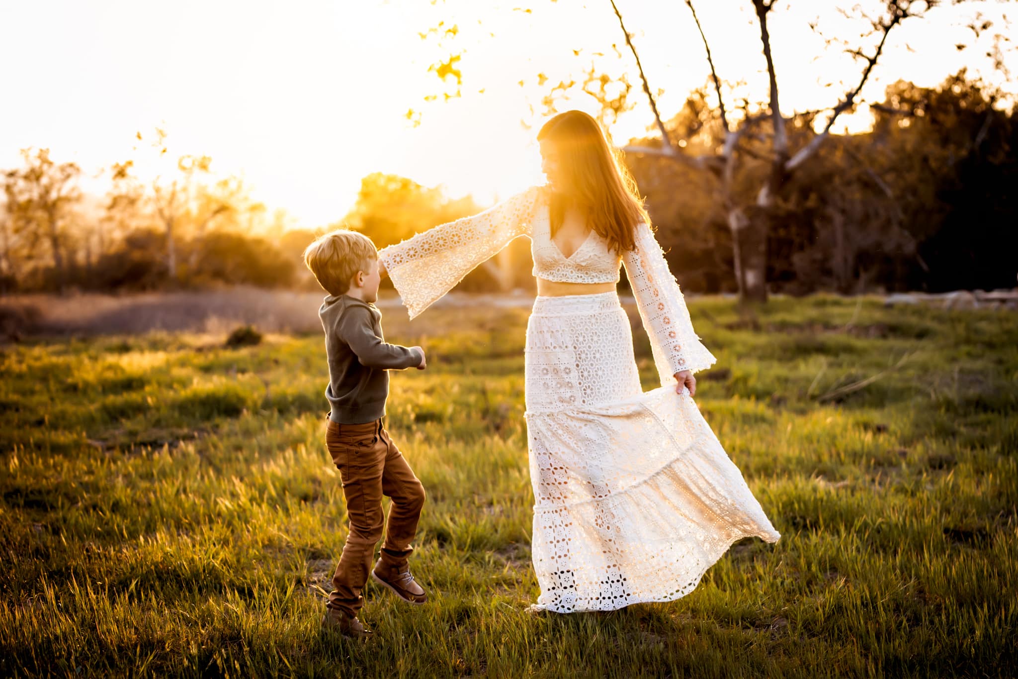 Mother wearing Free People dress dancing with her son