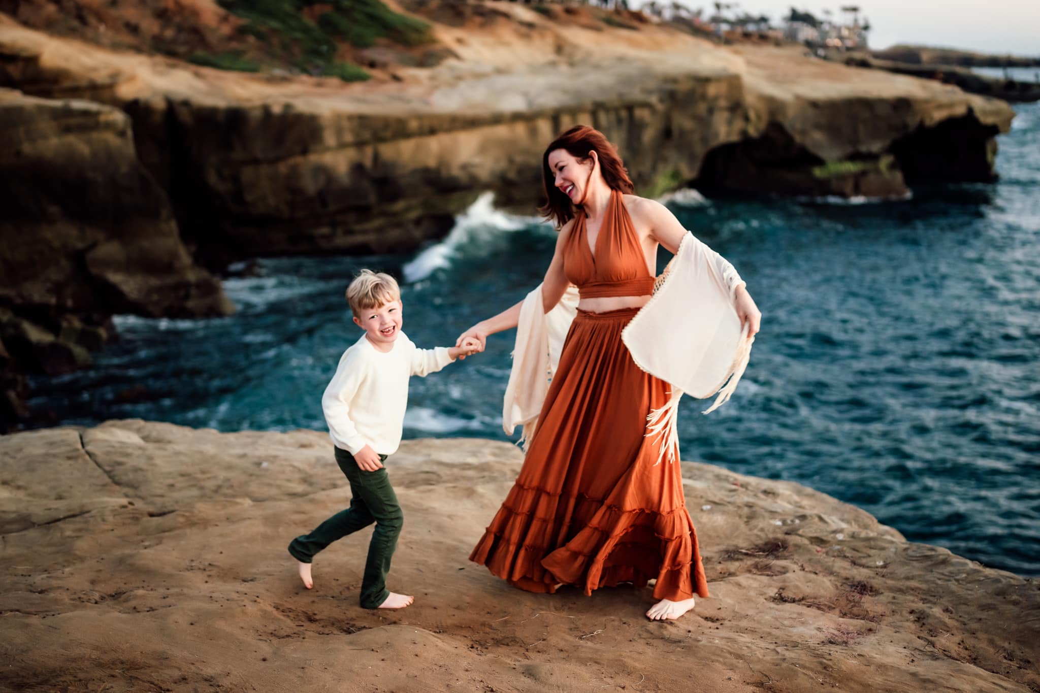 Mother and son wearing orange, cream, and green clothing in San Diego Family Photography session