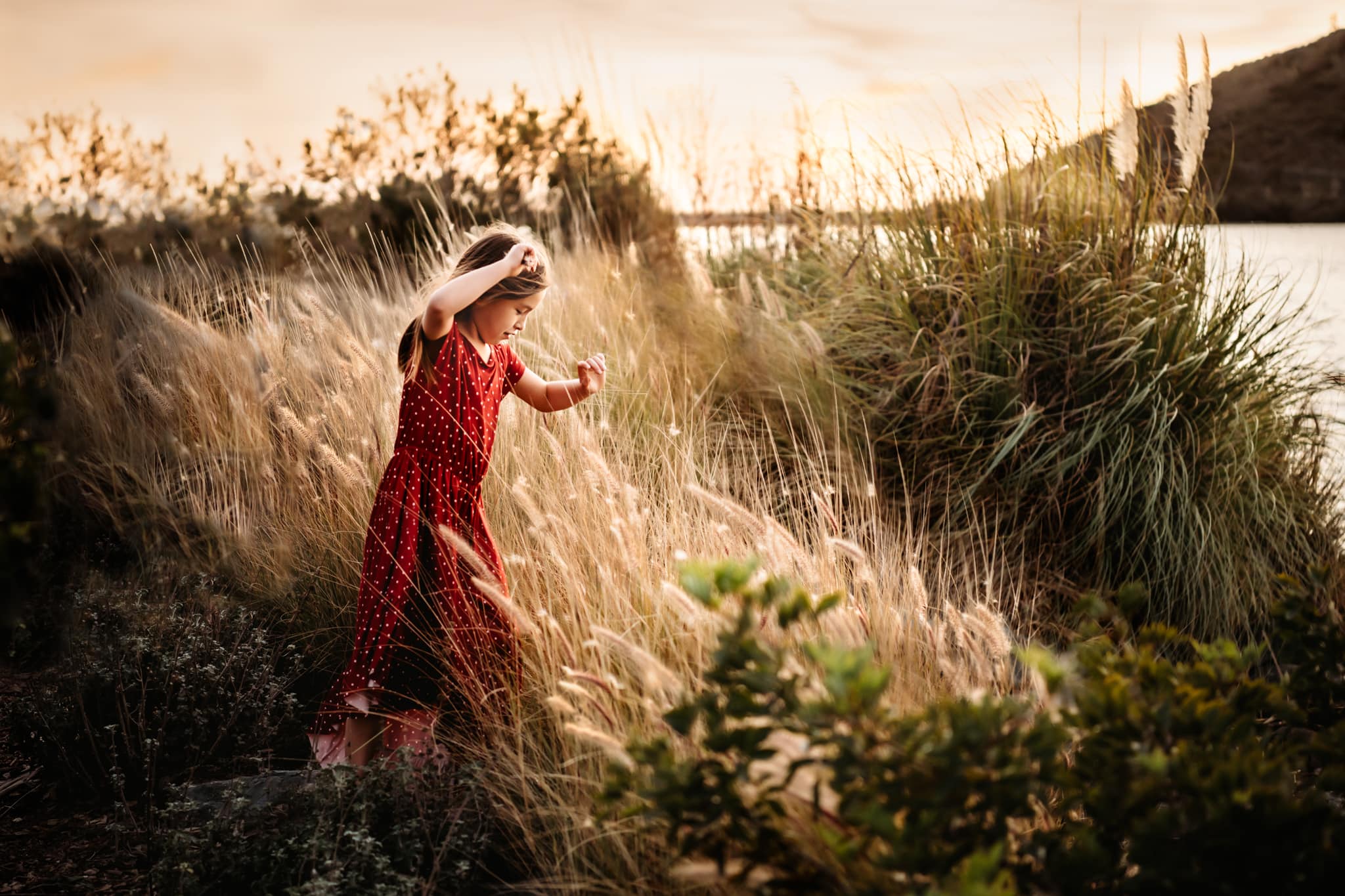 Girl twirling in Joyfolie dress at Lake Murray