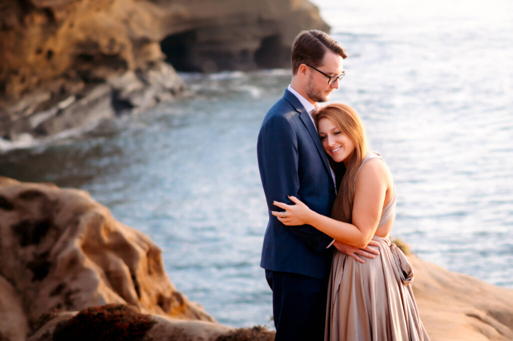 Couple hugging at Sunset Cliffs during photo session